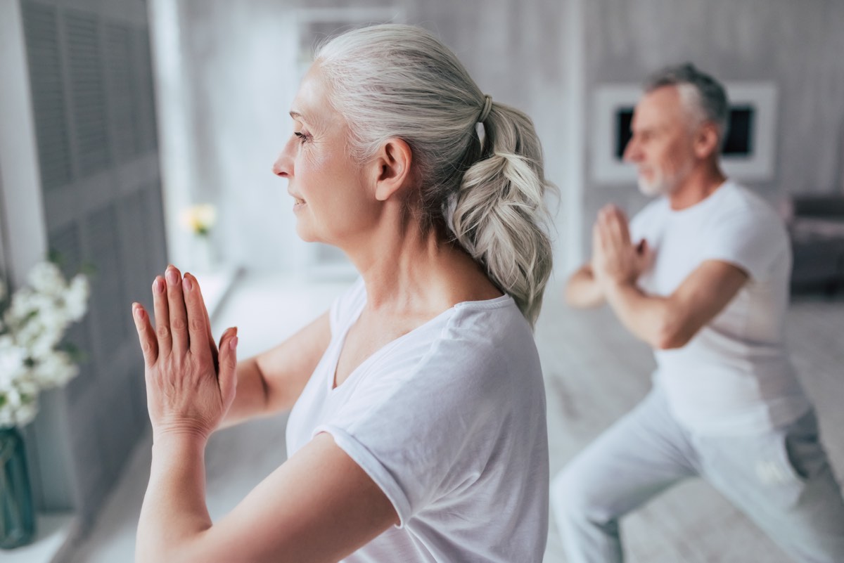 Senior Couple Yoga Standing Pose